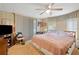 Main bedroom with a comfortable bed and ceiling fan at 7131 El Dewitt St, Zephyrhills, FL 33541