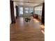 Bright sunroom featuring laminate floors and ample natural light at 7131 El Dewitt St, Zephyrhills, FL 33541