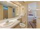 Bathroom with toilet, sink, and shower, plus bedroom view at 7131 El Dewitt St, Zephyrhills, FL 33541