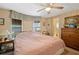 Spacious bedroom with large bed, dresser, and ceiling fan at 7131 El Dewitt St, Zephyrhills, FL 33541