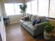 Sunroom features a light blue couch and two potted plants at 1306 Idlewood Dr # 53, Sun City Center, FL 33573