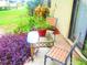 Small patio with table and chairs, surrounded by plants at 1306 Idlewood Dr # 53, Sun City Center, FL 33573