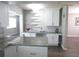 Modern kitchen with white cabinets, granite counters, and breakfast bar at 1306 Idlewood Dr # 53, Sun City Center, FL 33573