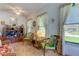 Bright sunroom features wicker seating, large windows, and a ceiling fan at 3283 Hilary Cir # 2C, Palm Harbor, FL 34684