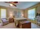 Cozy bedroom with a comfortable bed and ample natural light at 3283 Hilary Cir # 2C, Palm Harbor, FL 34684