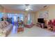 Living room featuring tiled floors, sofas, and a view to the lanai at 3283 Hilary Cir # 2C, Palm Harbor, FL 34684