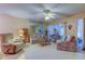 Bright living room with tile flooring, comfy seating, and ceiling fan at 3283 Hilary Cir # 2C, Palm Harbor, FL 34684
