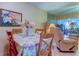 Bright dining area with floral tablecloth and view of living room at 3283 Hilary Cir # 2C, Palm Harbor, FL 34684