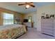 Bright bedroom with window, dresser, and ceiling fan at 3283 Hilary Cir # 2C, Palm Harbor, FL 34684