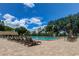 Sun-drenched community pool with lounge chairs at 3283 Hilary Cir # 2C, Palm Harbor, FL 34684