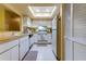 Bright eat-in kitchen features white cabinetry, wood countertops, and appliances at 3283 Hilary Cir # 2C, Palm Harbor, FL 34684