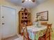 Cozy dining area with floral tablecloth, wooden chairs, and hutch at 3283 Hilary Cir # 2C, Palm Harbor, FL 34684