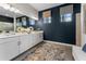 Modern bathroom with double vanity, stylish decor, and natural light from two large windows at 10385 Sunday Dr, Port Charlotte, FL 33981