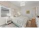 Bright, well-lit bedroom featuring neutral decor, a stylish window shade, and comfortable furnishings at 10385 Sunday Dr, Port Charlotte, FL 33981