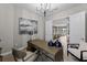 Modern home office with a spacious desk, stylish decor, and an open view to the living area at 10385 Sunday Dr, Port Charlotte, FL 33981