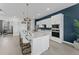 Modern kitchen features white cabinets, stainless steel appliances, and island with seating, ideal for Gathering gatherings at 10385 Sunday Dr, Port Charlotte, FL 33981