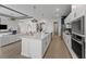 Open kitchen featuring stainless appliances, kitchen island, and seamless flow into the living area for easy entertaining at 10385 Sunday Dr, Port Charlotte, FL 33981