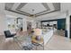 Spacious living room with wood floors and neutral tones, showcasing an open layout to the kitchen and dining areas at 10385 Sunday Dr, Port Charlotte, FL 33981