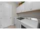 Laundry room with washer, dryer, and ample storage at 10386 Calumet Blvd, Port Charlotte, FL 33981