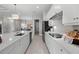 Modern kitchen with white cabinets, quartz countertops, and stainless steel appliances at 10386 Calumet Blvd, Port Charlotte, FL 33981