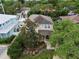 Two-story house with a porch, surrounded by lush trees and other homes at 3104 W Fielder St, Tampa, FL 33611