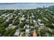Aerial view of neighborhood with lush trees and waterfront at 3104 W Fielder St, Tampa, FL 33611