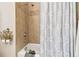 Clean bathroom with shower/tub combo and decorative tile at 3104 W Fielder St, Tampa, FL 33611