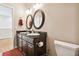 Double vanity bathroom with granite countertop and oval mirrors at 3104 W Fielder St, Tampa, FL 33611