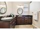 Bathroom with double vanity, granite countertop, and elegant mirrors at 3104 W Fielder St, Tampa, FL 33611