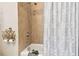 Bathroom with tub, shower, and decorative tile at 3104 W Fielder St, Tampa, FL 33611