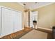 Well-lit bedroom with hardwood floors, neutral walls, double closets and a view into another room at 3104 W Fielder St, Tampa, FL 33611