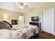 Spacious bedroom with hardwood floors and a flat-screen TV at 3104 W Fielder St, Tampa, FL 33611