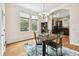 Charming dining room featuring a granite table, chandelier, and hardwood floors at 3104 W Fielder St, Tampa, FL 33611