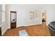 Bright entryway with hardwood floors, white door, and view into adjacent living space at 3104 W Fielder St, Tampa, FL 33611