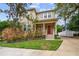 Two-story house with red door, front porch, and manicured lawn at 3104 W Fielder St, Tampa, FL 33611