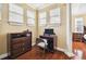 Home office features built-in desk and cabinets, hardwood floors, and large windows at 3104 W Fielder St, Tampa, FL 33611