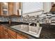 Sleek kitchen sink with granite countertop and tile backsplash at 3104 W Fielder St, Tampa, FL 33611