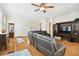 Open living room showcasing hardwood floors, a sectional sofa, and a large TV at 3104 W Fielder St, Tampa, FL 33611