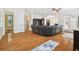 Spacious living room with hardwood floors, large sectional sofa, and access to outdoor patio at 3104 W Fielder St, Tampa, FL 33611