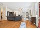 Open living room featuring hardwood floors, a large sectional sofa, and access to the kitchen at 3104 W Fielder St, Tampa, FL 33611