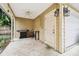 Covered patio with grill, small table, and access to garage at 3104 W Fielder St, Tampa, FL 33611