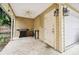 Covered patio with grill, small table, and access to garage at 3104 W Fielder St, Tampa, FL 33611