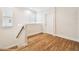 Upper hallway with hardwood floors and a white door at 3104 W Fielder St, Tampa, FL 33611