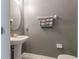 Small half bathroom with pedestal sink and gray walls at 409 Serenity Mill Loop, Ruskin, FL 33570