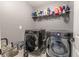 Well-equipped laundry room with LG washer and dryer, and ample shelving at 409 Serenity Mill Loop, Ruskin, FL 33570