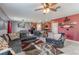 Open living room with L-shaped sectional sofa and access to kitchen at 409 Serenity Mill Loop, Ruskin, FL 33570