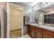 Clean bathroom with a double vanity and walk-in closet at 409 Serenity Mill Loop, Ruskin, FL 33570
