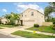Two story house with beige exterior, two car garage, and palm trees at 409 Serenity Mill Loop, Ruskin, FL 33570