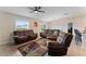 Bright living room with comfortable leather furniture and a view of the dining area at 10005 Caraway Spice Ave, Riverview, FL 33578