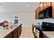 View of kitchen with granite countertops and black appliances at 10005 Caraway Spice Ave, Riverview, FL 33578